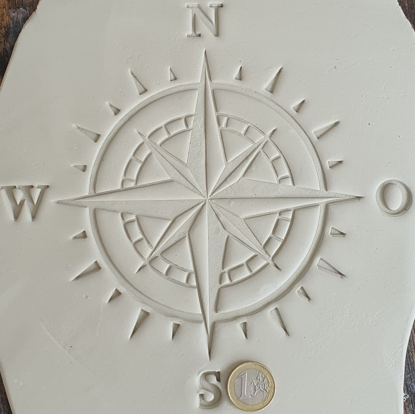 Stamp plate compass wind rose