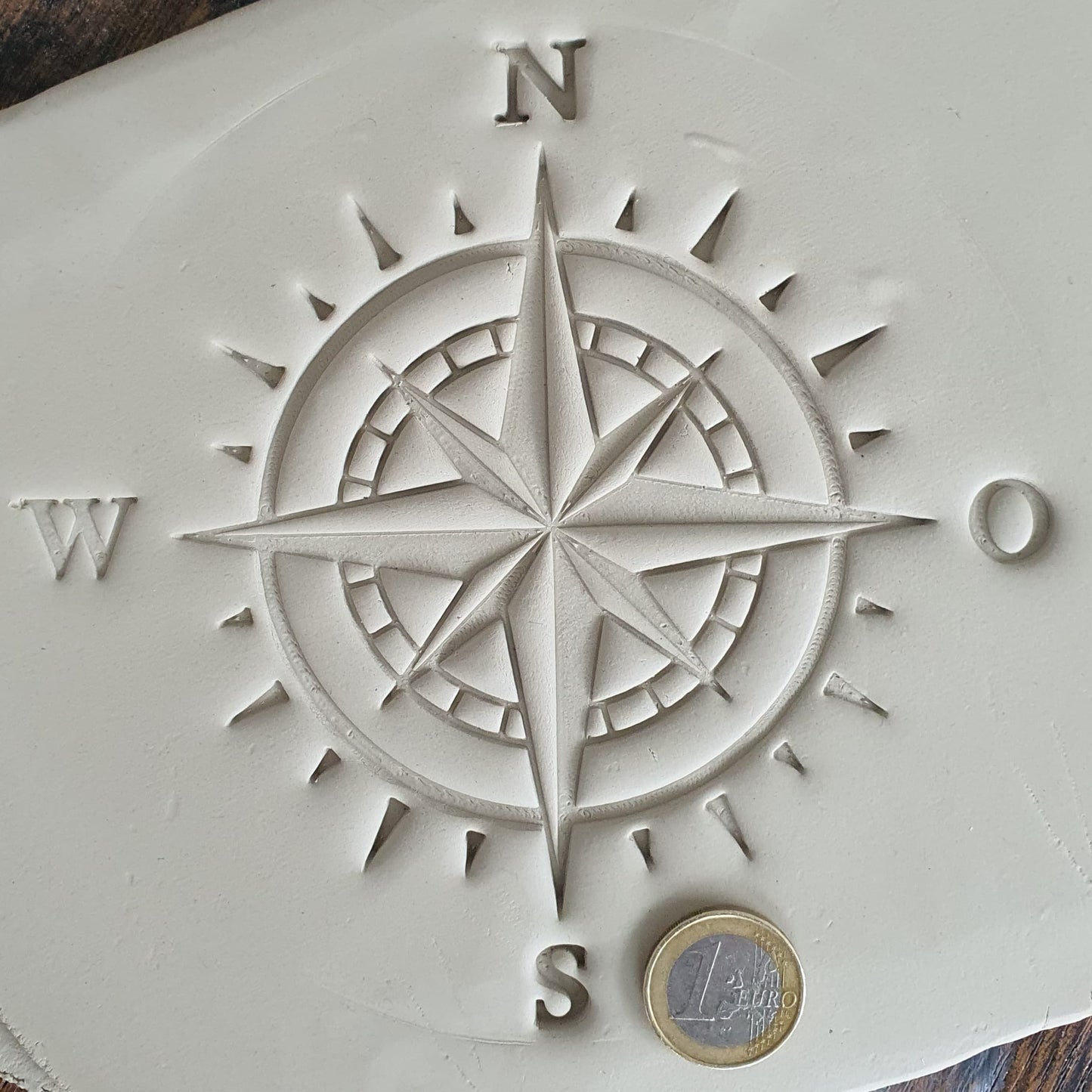 Stamp plate compass wind rose